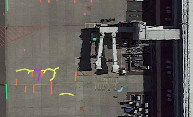 Aerial view of airport apron with AI-detected pavement defects overlaid